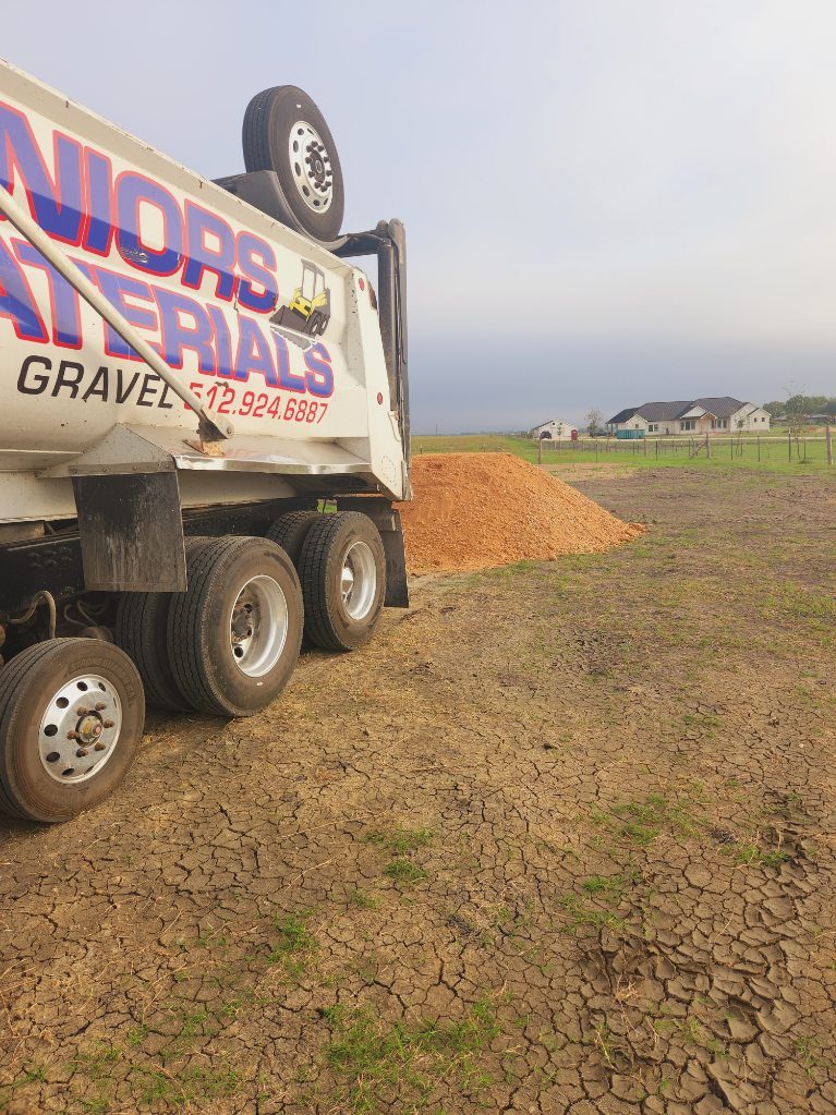 A Juniors Materials truck delivering landscape material.
