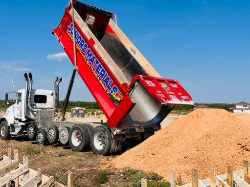 A Juniors Materials dump trailer unloading aggregate