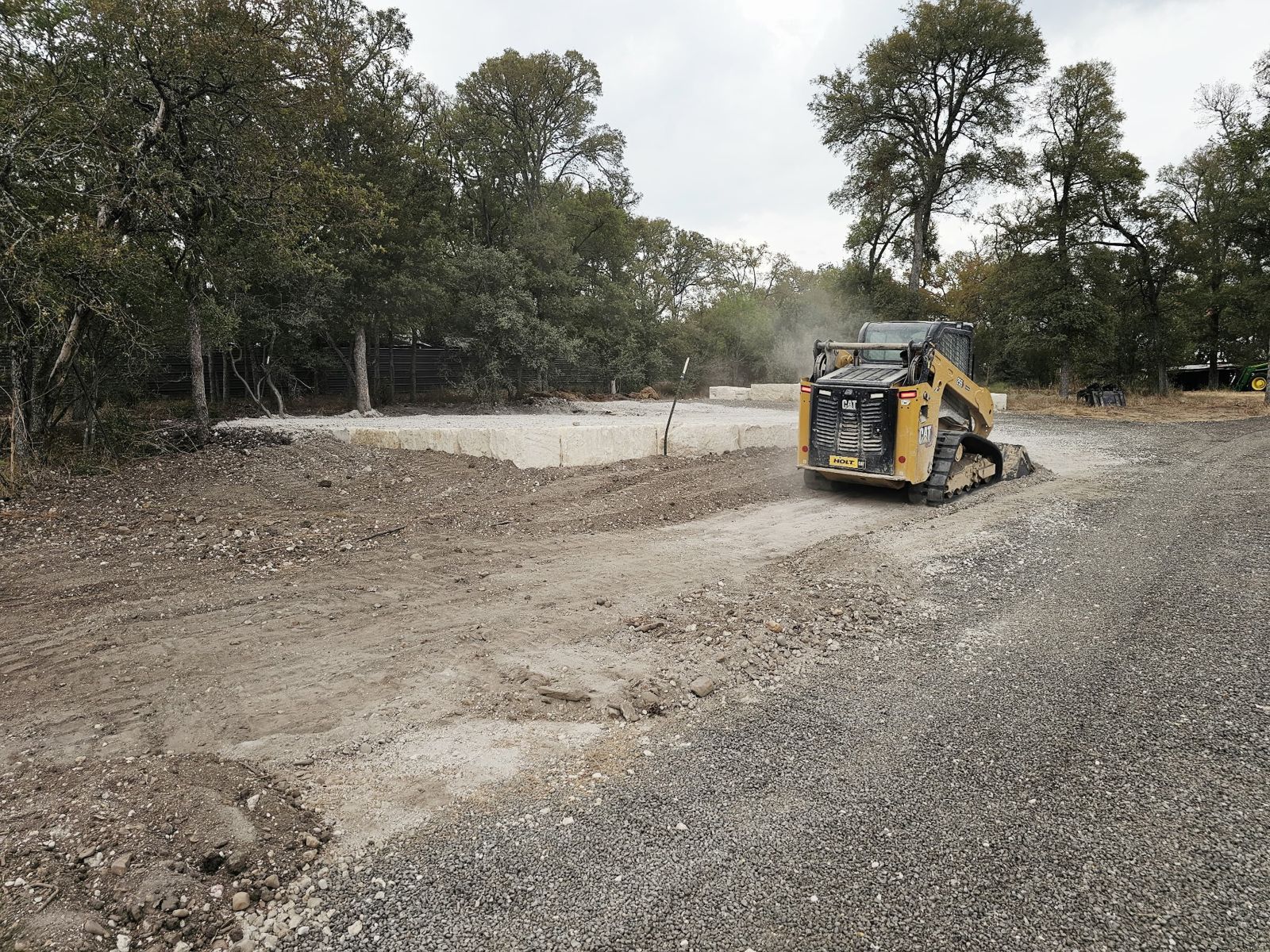 A skid steer working on a Juniors Materials job.